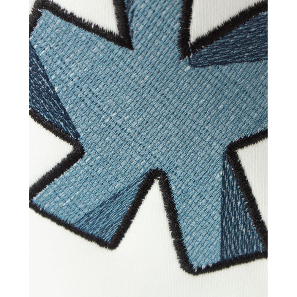 Close-up of logo embroidery on Comme Des Fuckdown White Cotton Jeans & Pant highlighting the detailed stitch design.