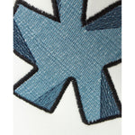 Close-up of logo embroidery on Comme Des Fuckdown White Cotton Jeans & Pant highlighting the detailed stitch design.