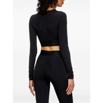 Woman wearing Diesel Sweaters Black long sleeves round neck cropped top, black color, side view. Fashion clothing.