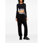 Model wearing Diesel Sweaters Black with a black long sleeve, round neck, cropped top featuring a front logo design.