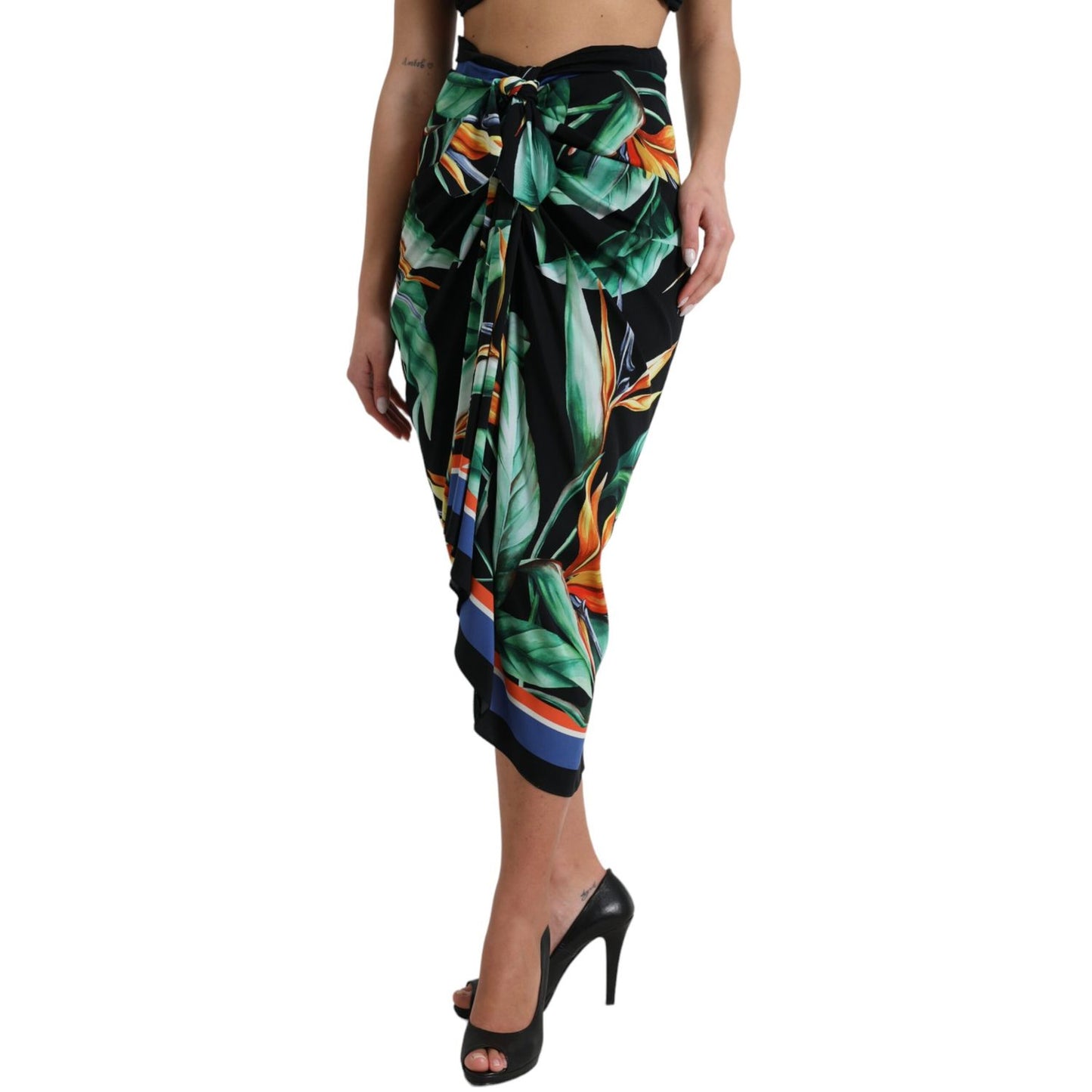 Woman wearing Dolce & Gabbana Black Strelitzia High Waist Wrap Midi Skirt with floral pattern and high heels.
