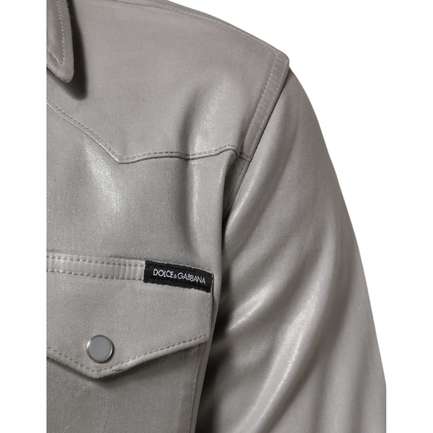 Close-up of Dolce & Gabbana Gray Coated Cotton Snap Button Logo Men Shirt with metallic finish and logo tag detail on chest pocket.