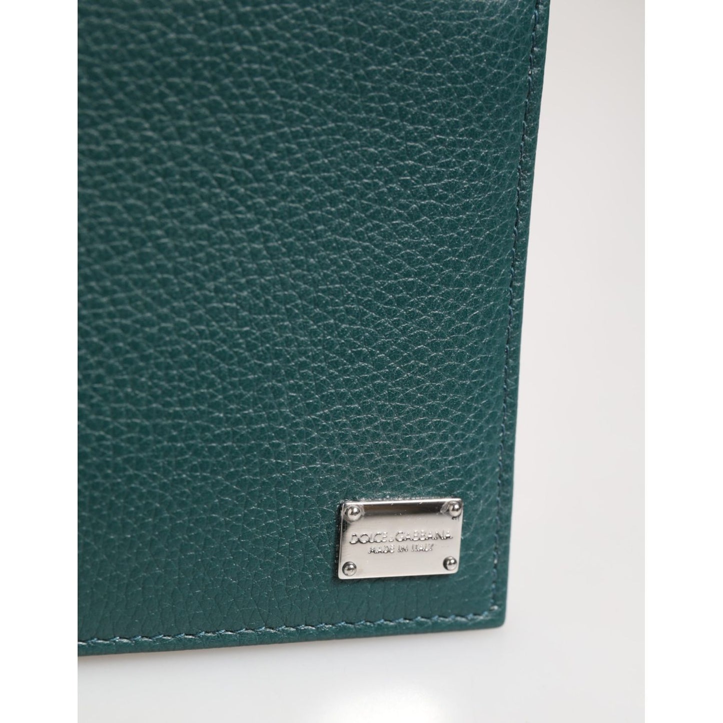 Dolce & Gabbana Green Leather DG Logo Plaque Bifold Card Holder Wallet close-up showing pebbled leather texture and logo plaque.