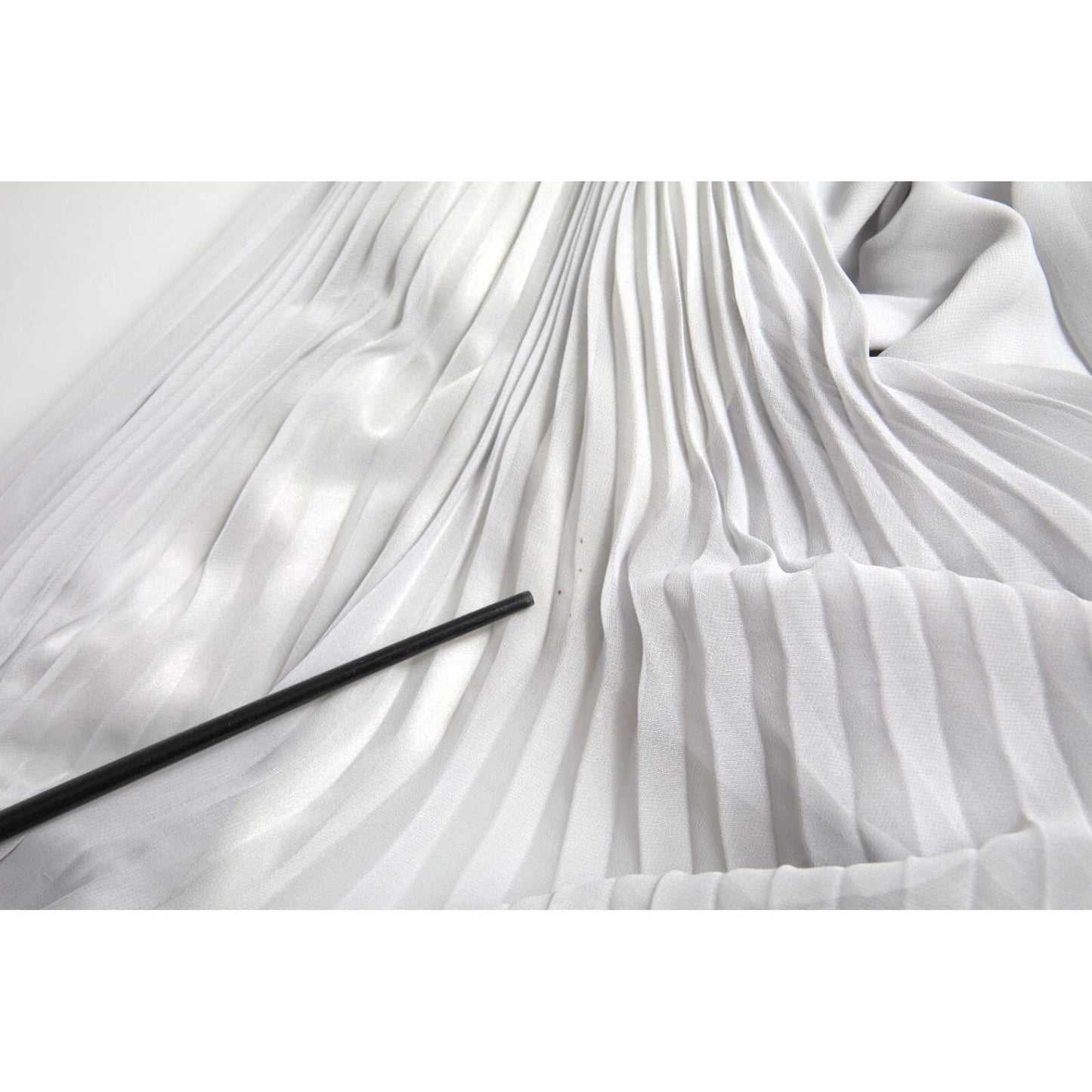 Close-up of Dolce & Gabbana Light Grey Polyester Pleated Long Maxi Dress fabric with minor stain detail.