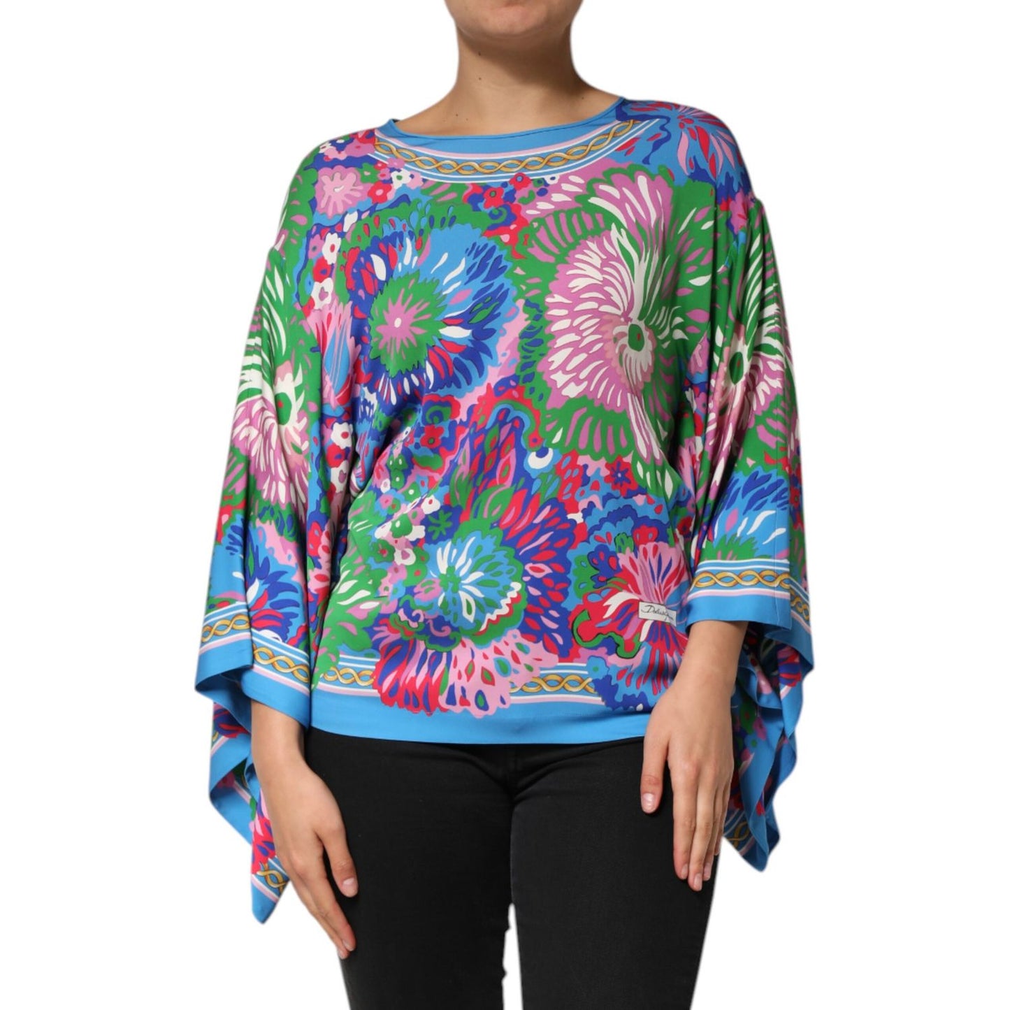 Woman wearing Dolce & Gabbana Multicolor Floral Print Silk Tunic Blouse Top with vibrant floral patterns on a relaxed silhouette.