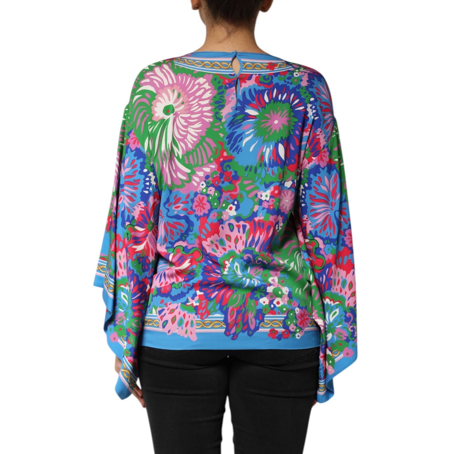 Back view of a Dolce & Gabbana Multicolor Floral Print Silk Tunic Blouse Top, showcasing vibrant floral patterns.