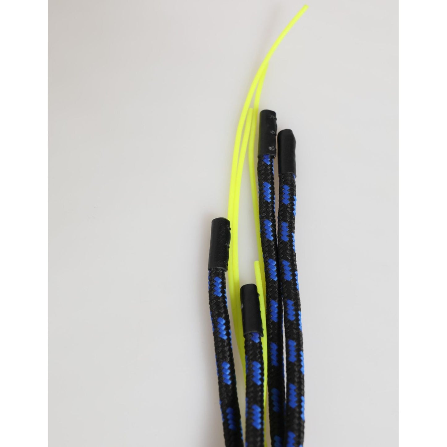 Close-up of black and blue climbing rope with neon yellow strands against a neutral background.