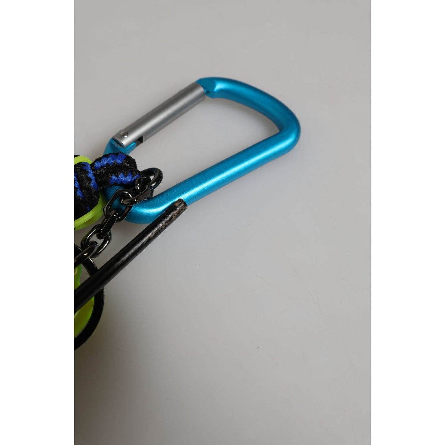 Close-up of Dolce & Gabbana Multicolor Polyester Tape String DG Logo Keychain Keyring showing blue metal carabiner detail.