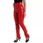 Model wearing Dolce & Gabbana Red High Waist Skinny Trouser Shiny Pants with zipper closure and logo details.