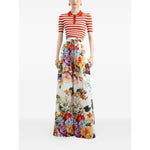 Model wearing Dolce & Gabbana Striped Polo Top with short sleeves, button placket, and floral wide-leg pants for a stylish ensemble.