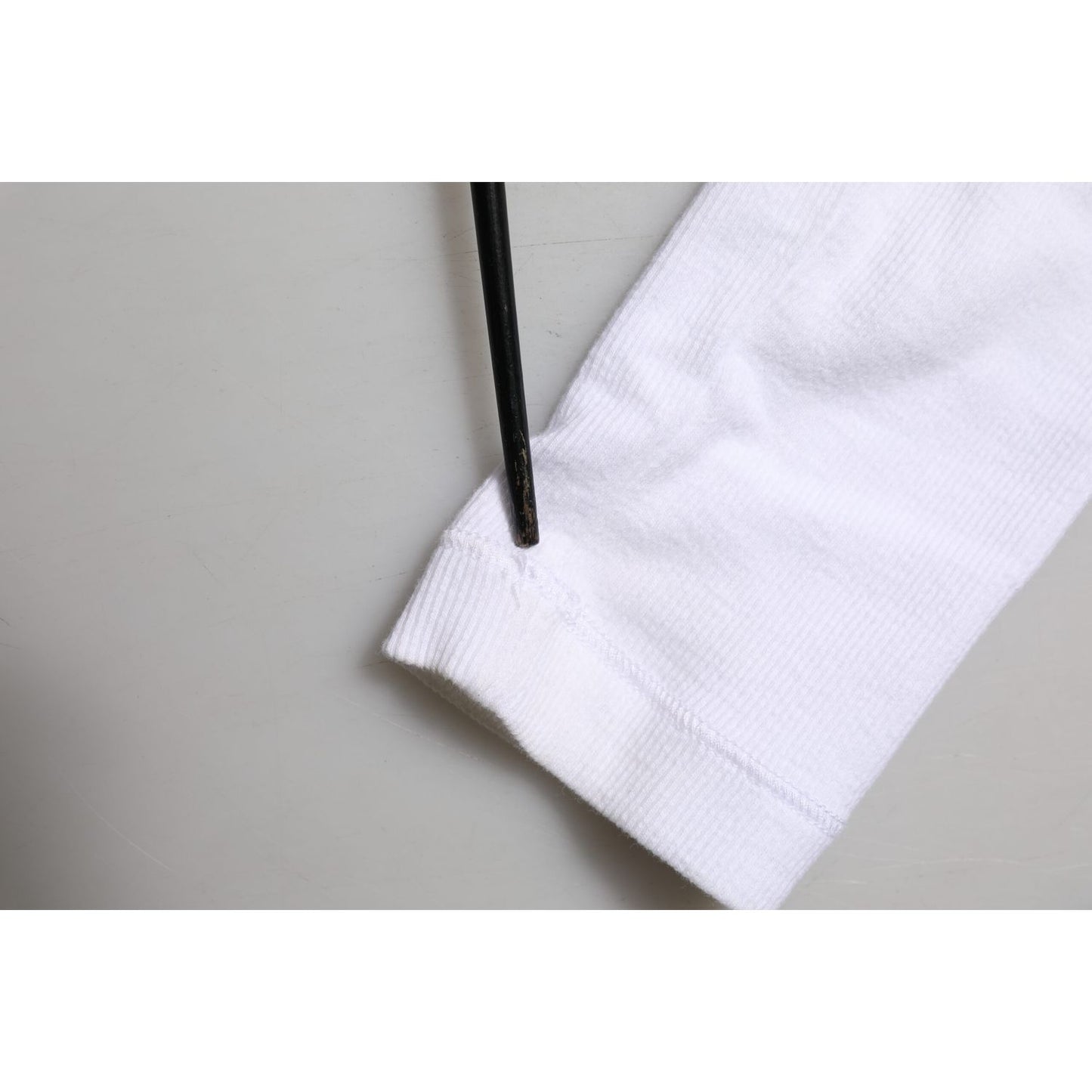Close-up of Dolce & Gabbana White Long Sleeves Button Closure T-shirt showing minor sleeve discoloration.