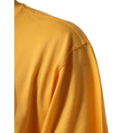 Close-up of Dolce & Gabbana Yellow Secret Graden Floral Cotton CrewNeck T-shirt sleeve detail, featuring vibrant yellow cotton fabric.