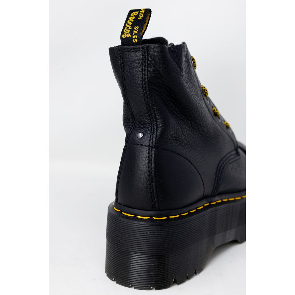 Dr. Martens Black Leather Boot with rubber sole and lace-up closure, showcasing high-quality leather and iconic design.