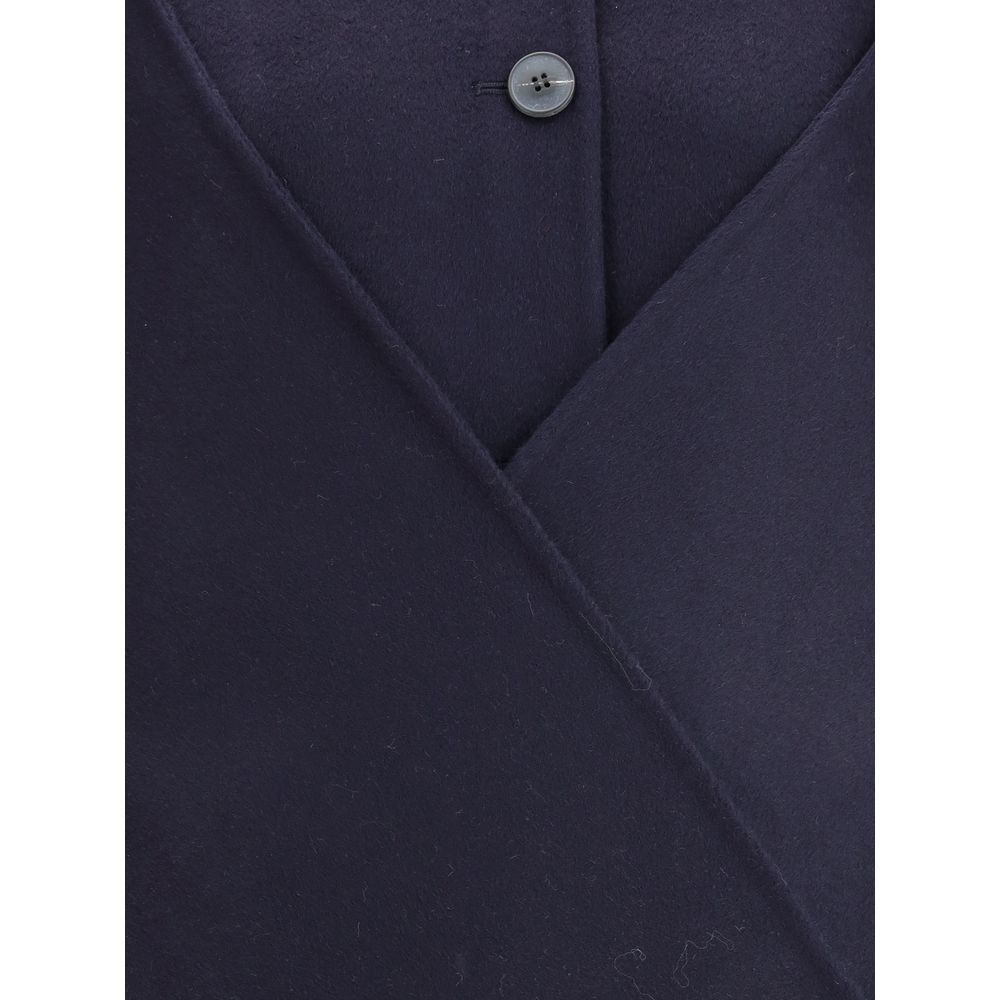 Close-up of Dynamis Studio Blue Wool Coat showing button detail and wool texture.