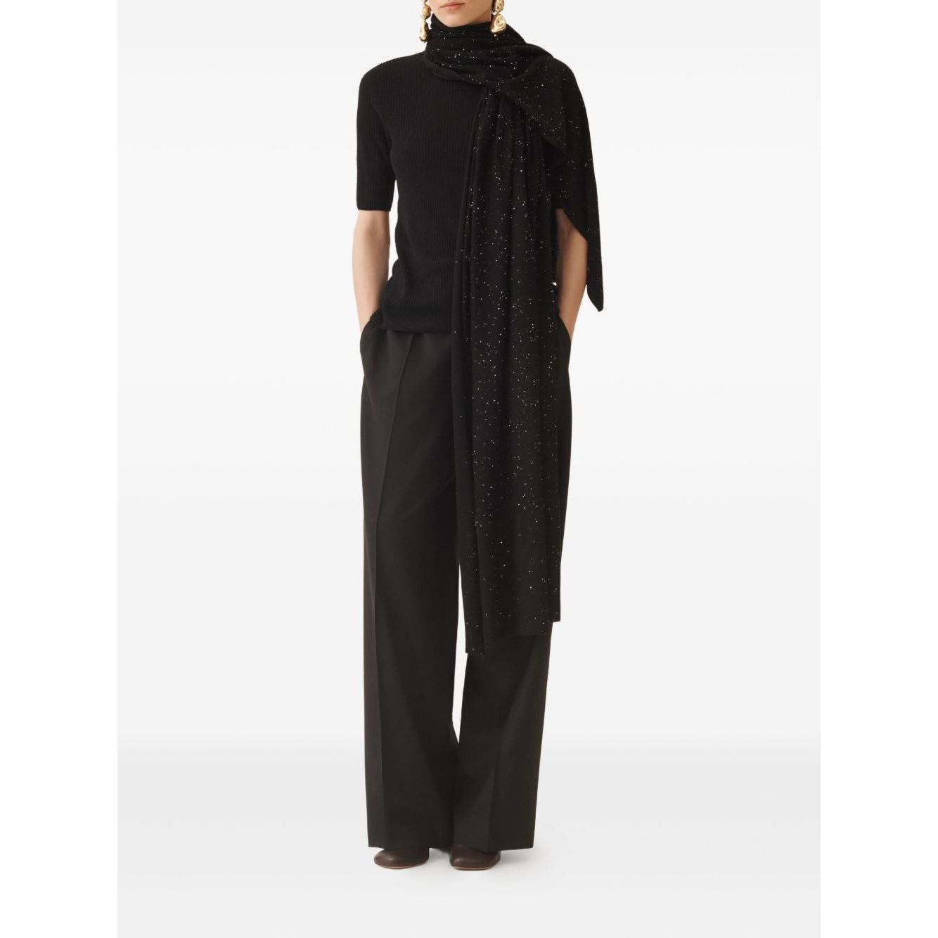 Model wearing Fabiana Filippi sequin embellishment Wool scarf in black with a ribbed texture, styled with black wide-leg pants.
