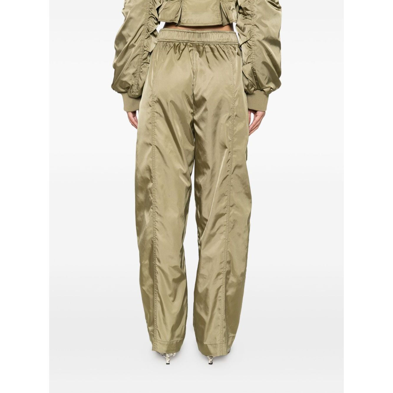 Back view of GANNI Trousers Green with elasticated waistband, cargo pockets, and seam detailing in sage green nylon.