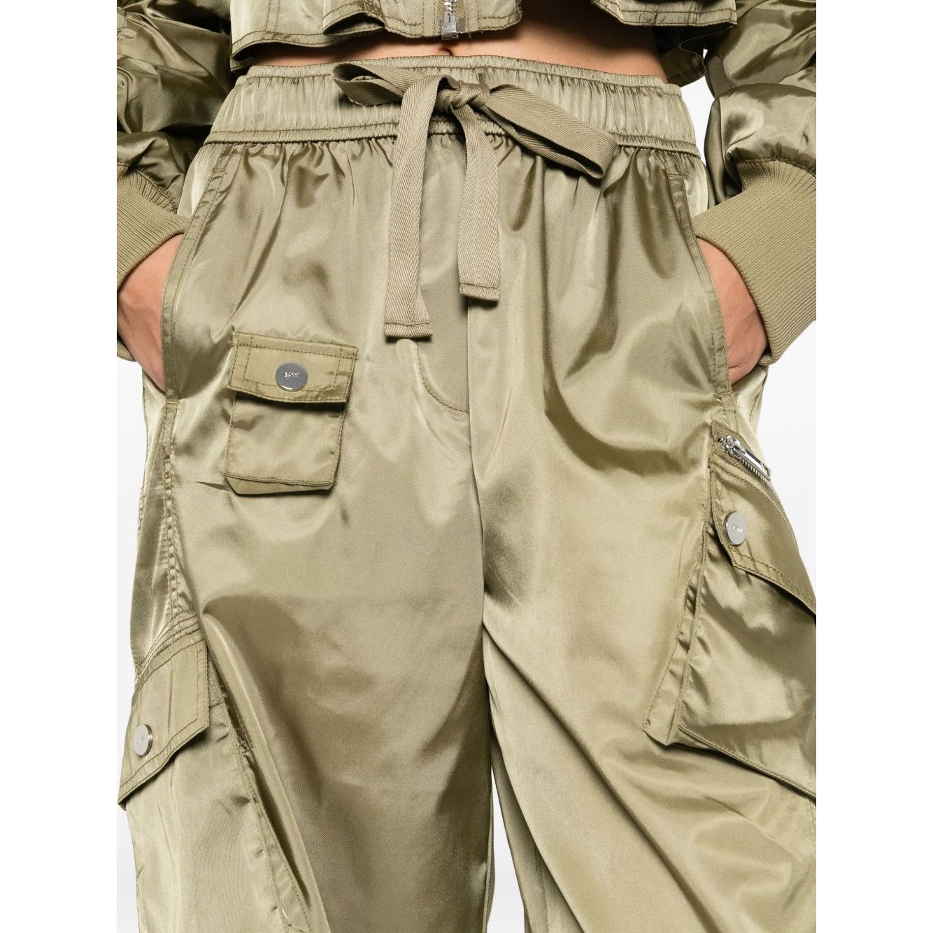 GANNI Trousers Green in sage with elasticated waistband, cargo pockets, seam detailing, and drawstring tie for a stylish oversized look.