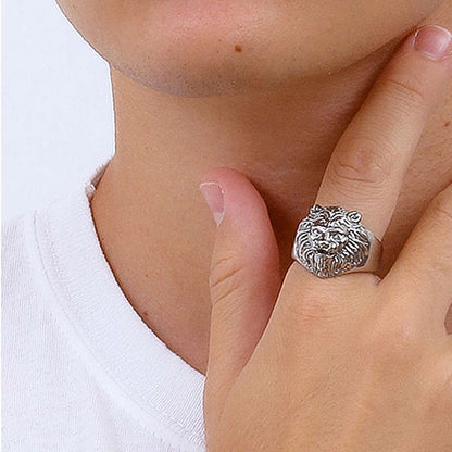 Person wearing lion design ring on finger, showcasing animal-themed jewelry fashion.