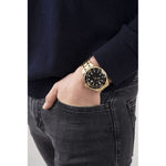 Gent's wrist with GUESS Mod. PREMIER wristwatch, quartz movement, water-resistant 3 ATM, featuring a sleek design in official packaging.