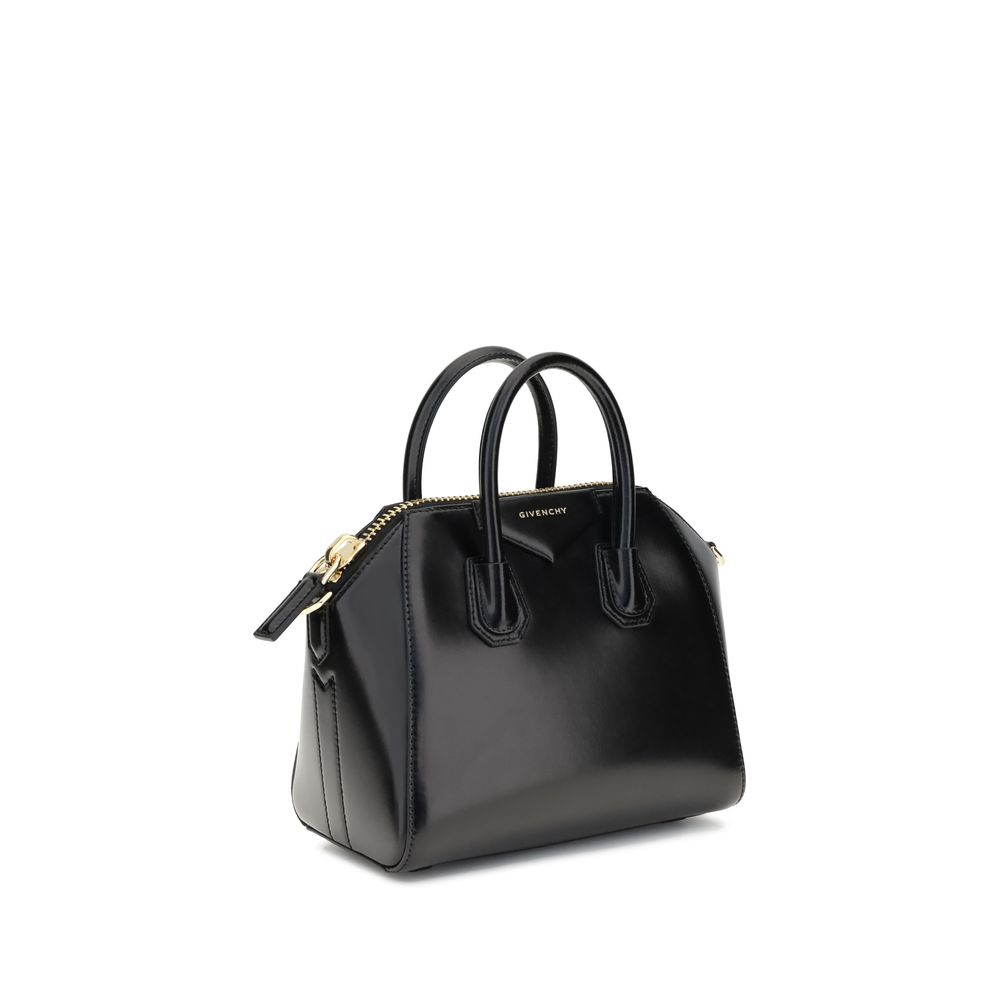 Givenchy Black Calf Leather Bos Taurus Handbag with glossy finish and geometric pattern, featuring top handles and an adjustable shoulder strap.