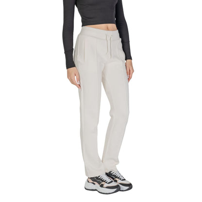 Woman wearing Guess Active Cream Cotton Joggers (Workout Pants) for gym or casual outings, straight leg design, comfortable fit, versatile style.
