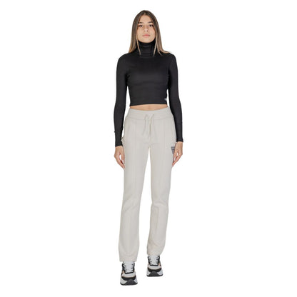 Woman wearing Guess Active Cream Cotton Joggers (Workout Pants) styled for workout or casual outing.