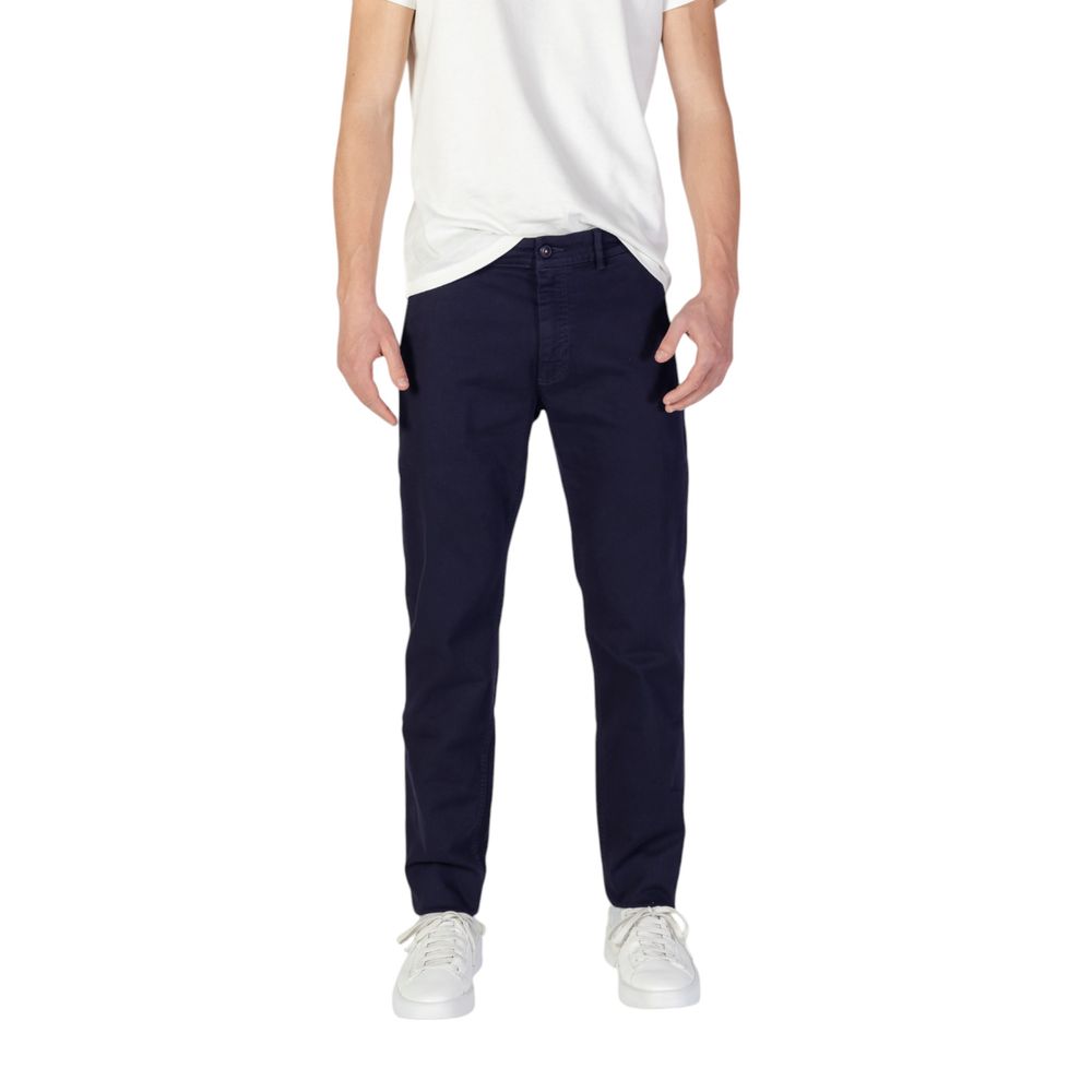 Man wearing Hugo Boss Blue Cotton Skinny Pants with white sneakers and a white t-shirt for a modern style.