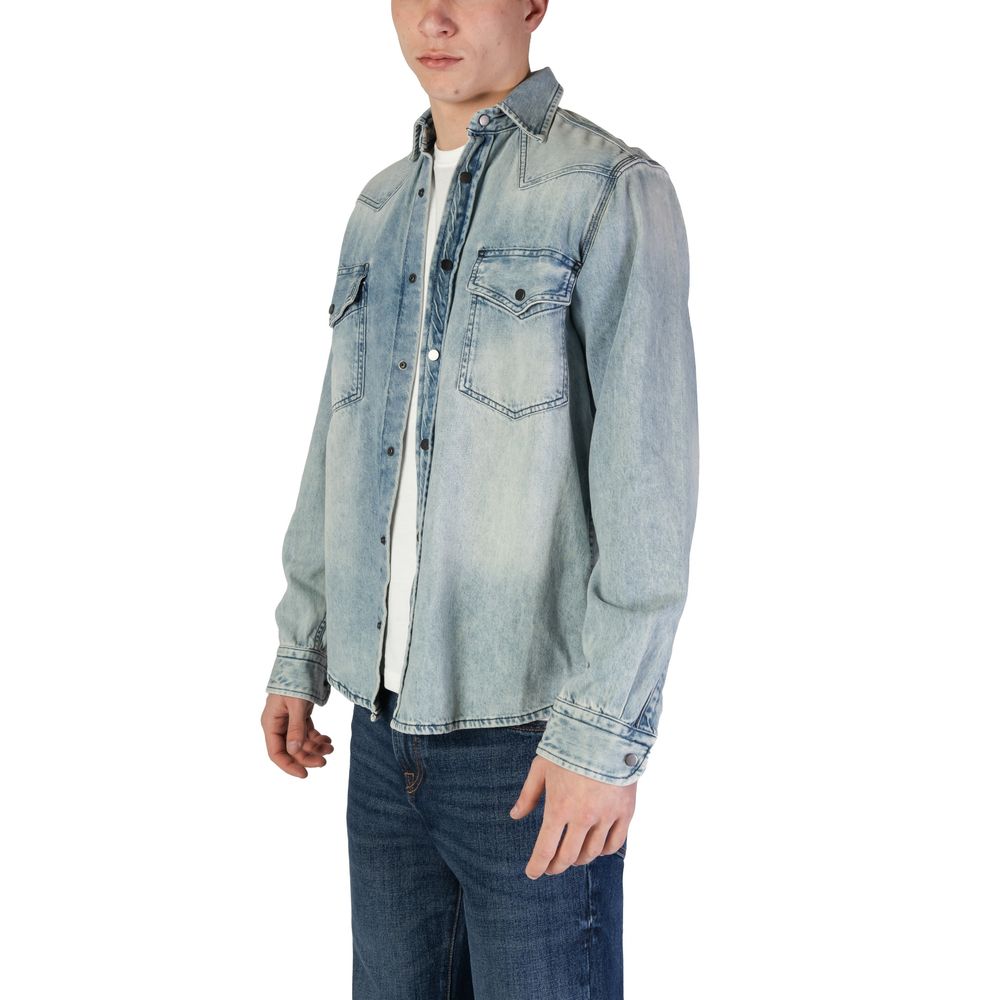 Hugo Boss Light Blue Denim Shirt featuring long sleeves, snap-button closure, and chest pockets, perfect for casual and polished looks.