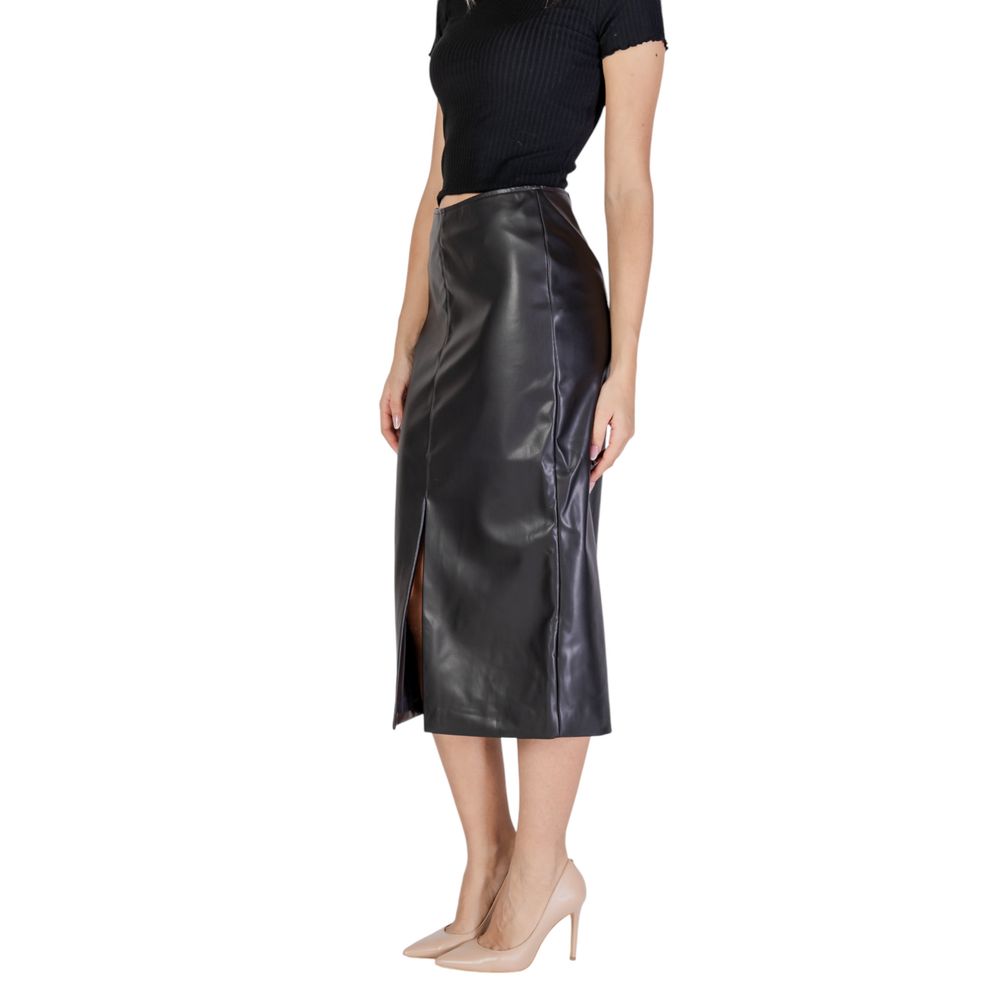 Woman wearing ICHI Black Polyester Long Skirt with leather-effect finish and high waist, featuring front slit for elegant and modern look.