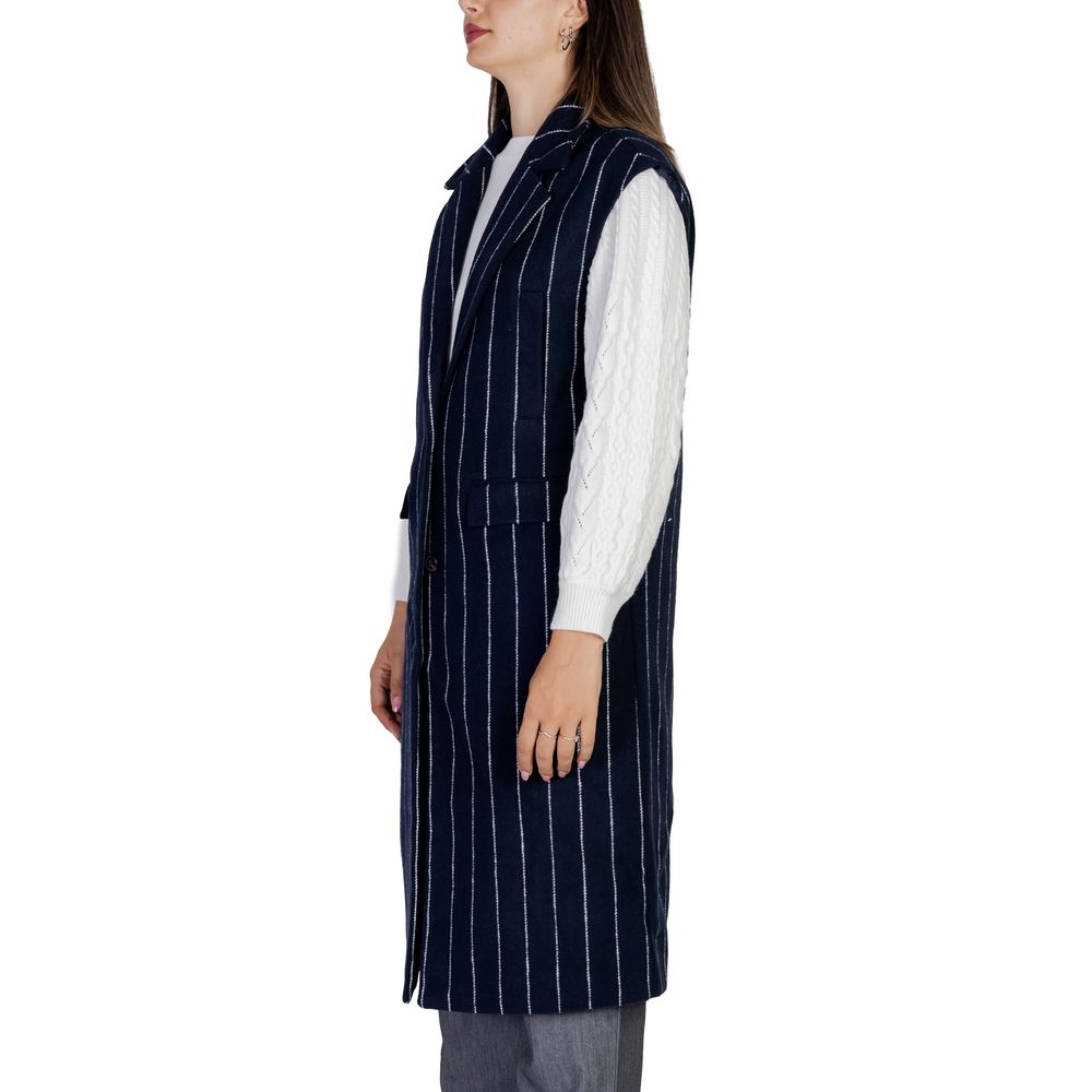 Woman wearing ICHI Blue Polyester Sleveless Jacket with pinstripes, showcasing longline design and wide lapels.
