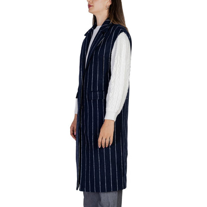 Woman wearing ICHI Blue Polyester Sleveless Jacket with pinstripes, showcasing longline design and wide lapels.