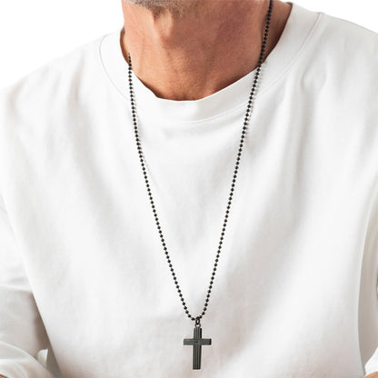 Person wearing a white shirt with a black cross necklace.