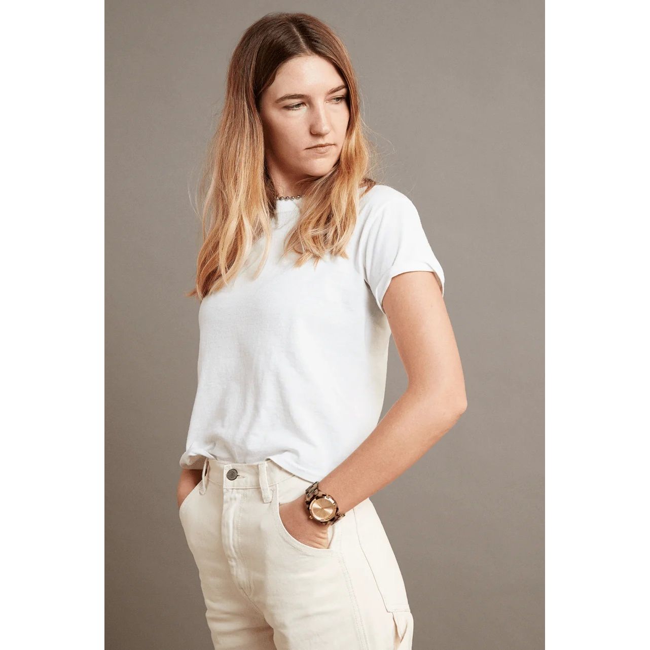 Woman wearing NIXON WATCHES Mod. A327-3346 on wrist, featuring an acetate case and strap, shown in casual outfit.