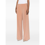 Norma Kamali Trousers Beige with elasticated waistband and wide-leg design, featuring two side inset pockets, high-waisted fit.