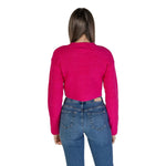 Back view of woman wearing an Only Pink Recycled Polyester Sweater, fall/winter collection, showcasing vibrant pink knitwear.