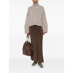 Woman wearing SOFT GOAT Sweaters Light Grey cashmere turtle-neck jumper with taupe grey ribbed trim and long sleeves, holding a brown bag.