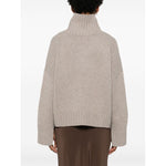 Back view of SOFT GOAT Sweaters Light Grey on model, featuring taupe grey ribbed trim, high neck, drop shoulder, and long sleeves.