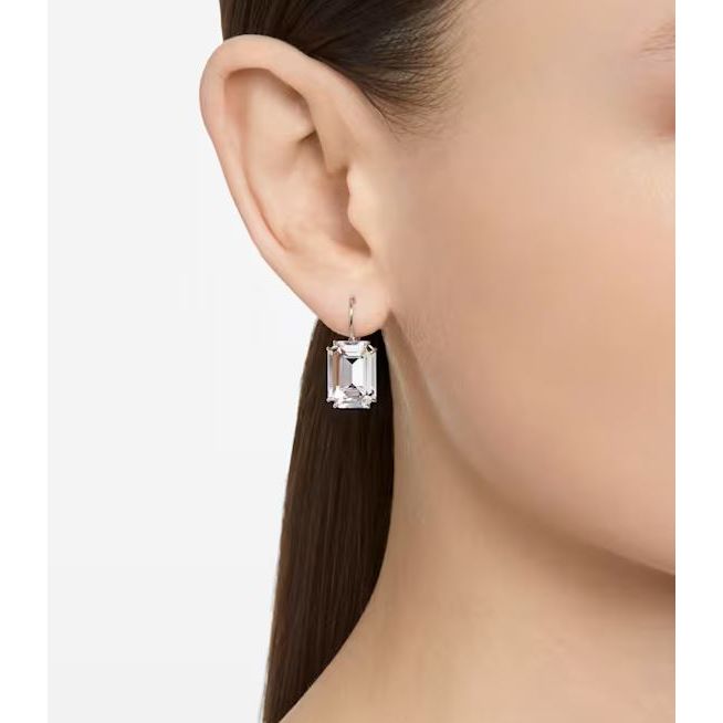Elegant lady wearing SWAROVSKI Mod. 5636569 earrings in silver with quartz movement, shown in official box packaging, water resistant to 5 ATM.