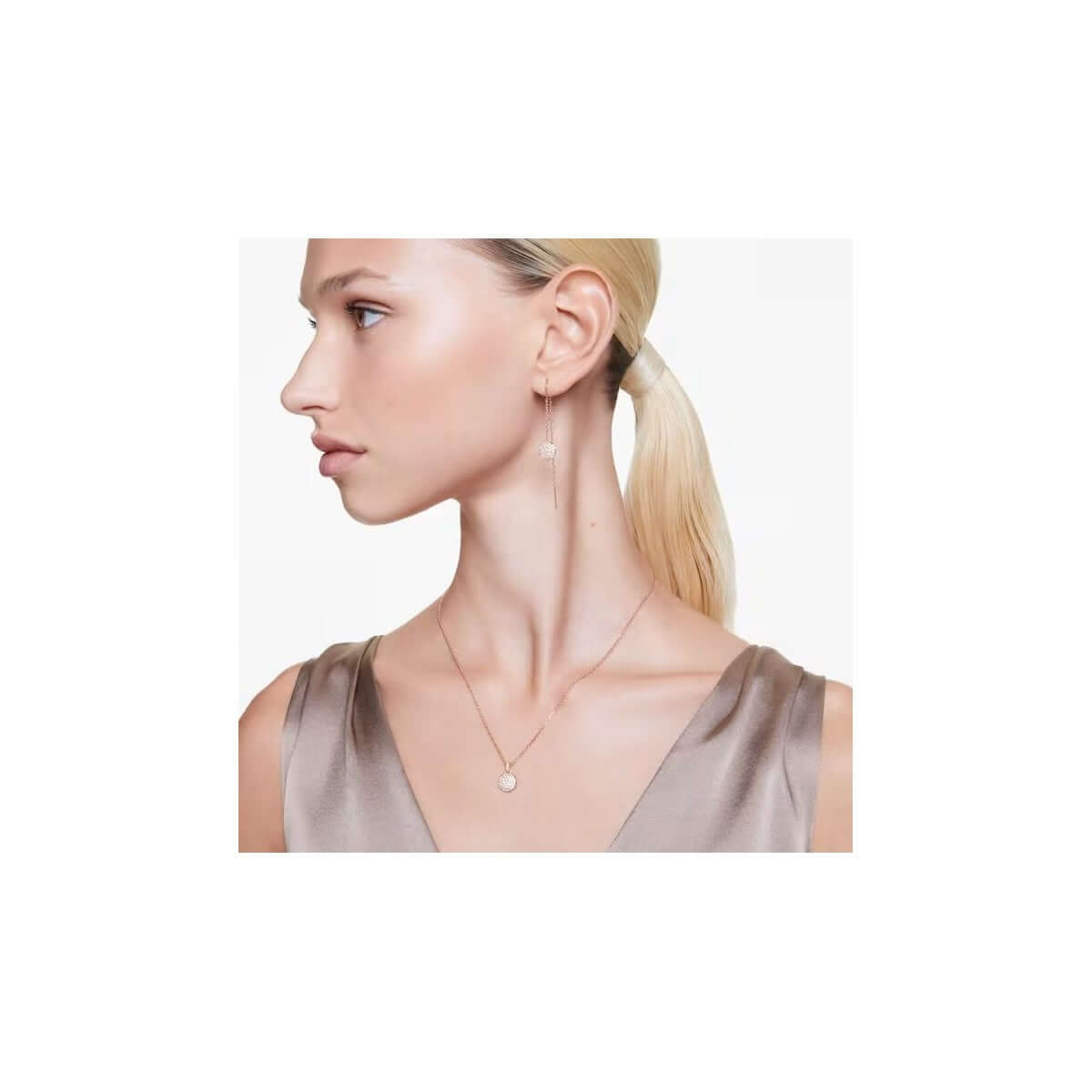 Woman wearing Swarovski Mod. 5683451 silver 925° earrings with quartz analog movement, showcased in official packaging.