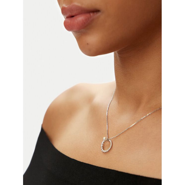 Woman wearing SWAROVSKI Mod. 5688751 necklace in silver 925°, elegant quartz analog design, showcasing delicate round pendant.