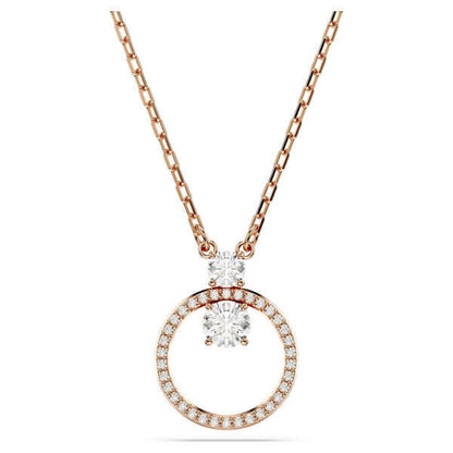 Elegant rose gold necklace with circular pendant and crystal details. Perfect accessory for a stylish outfit. Fashion jewelry.