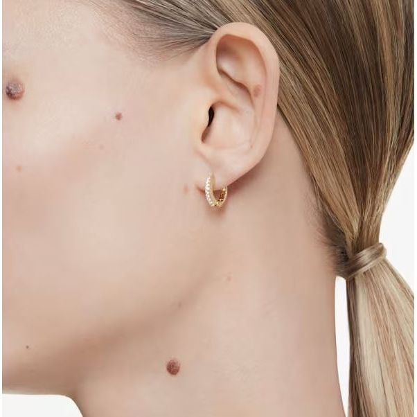 Side view of person wearing SWAROVSKI Mod. 5697228 earrings, showcasing sparkling design and elegant style.