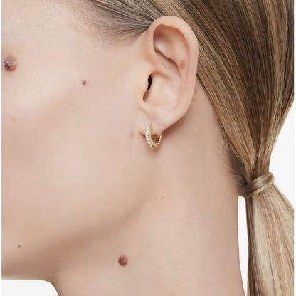 Side view of person wearing SWAROVSKI Mod. 5697228 earrings, showcasing sparkling design and elegant style.