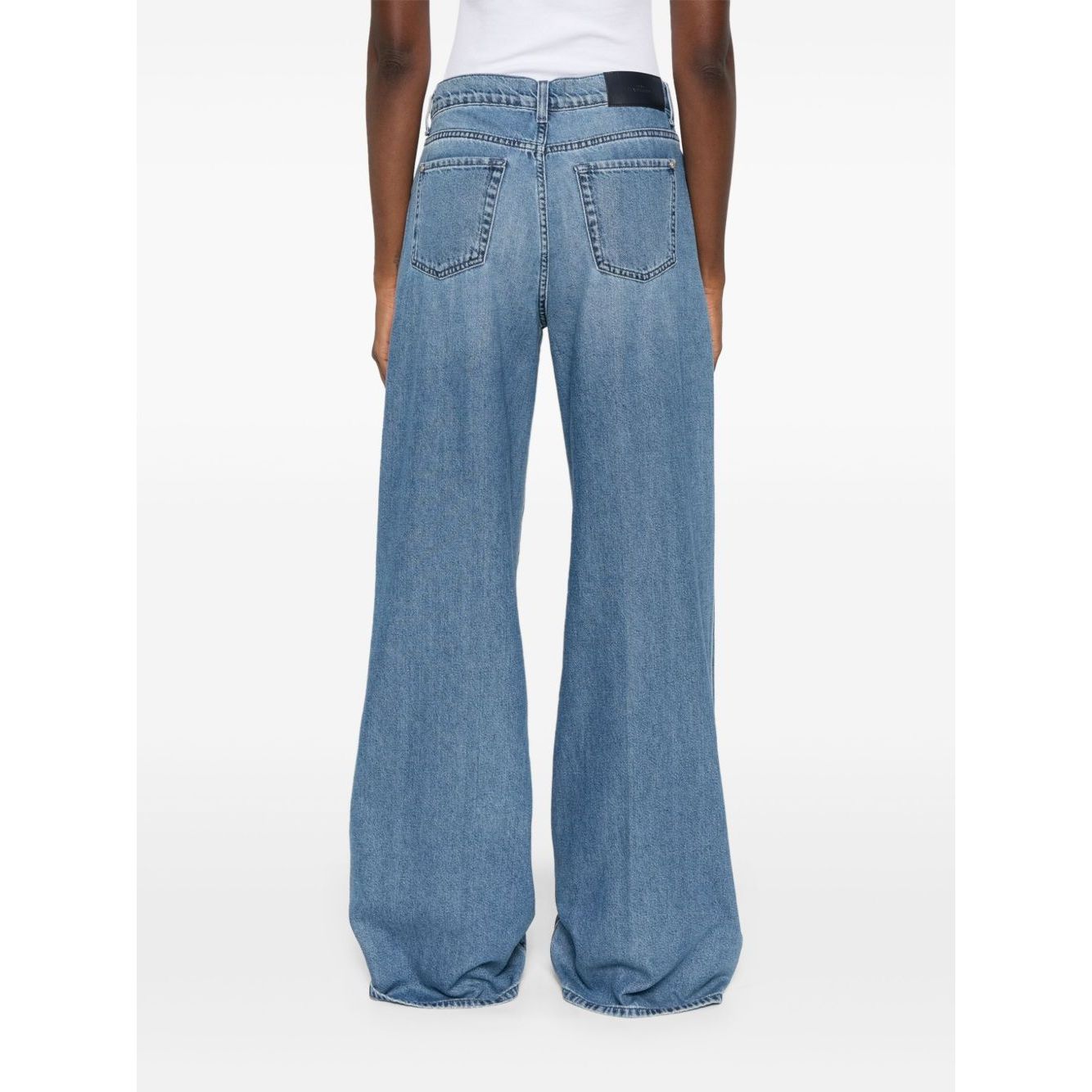 Back view of Seven Jeans Blue wide-leg denim jeans with logo patch, belt loops, and two rear pockets.