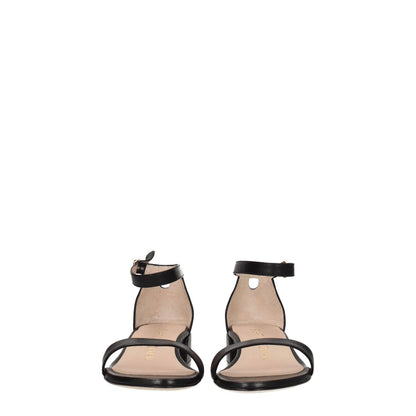 Stuart Weitzman Black Leather Flat Sandals with buckle closure, open toe, and mid heels, ideal for casual wear. MPN: NUDISTJUNESMOS6743BLACK.