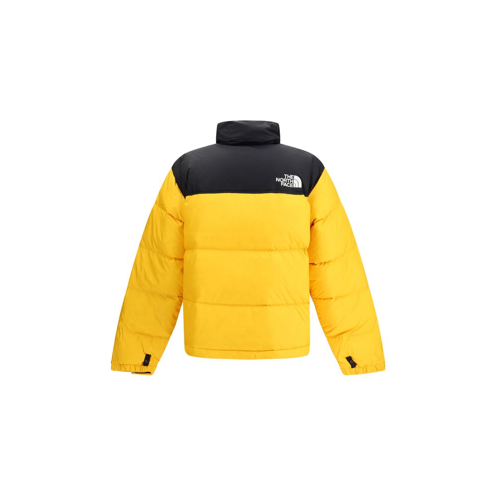 The North Face Yellow Polyamide Shell Jacket with high collar and removable hood, featuring padded design and bold yellow-and-black colorway.