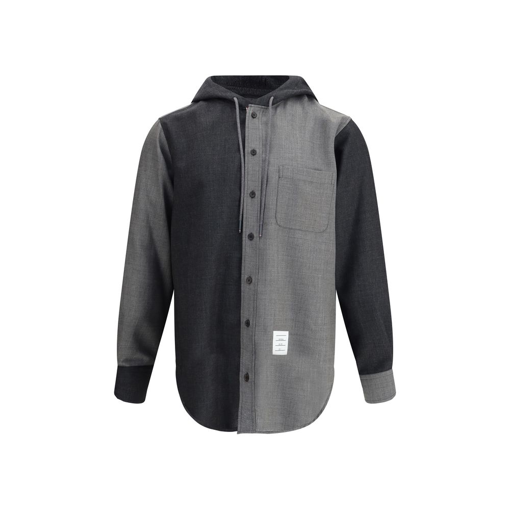Thom Browne Hooded Shirt Jacket with patch pocket and asymmetrical hem in black and grey, featuring adjustable hood and button closure.