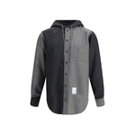 Thom Browne Hooded Shirt Jacket with patch pocket and asymmetrical hem in black and grey, featuring adjustable hood and button closure.