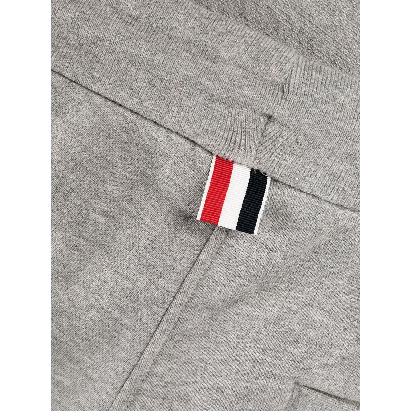 Close-up of Thom Browne Trousers Grey showing 4-Bar stripe and grosgrain loop tab detail.