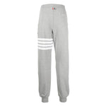 Alt Tag: Thom Browne Trousers Grey, cotton sweatpants with 4-Bar stripe, grosgrain loop tab, drawstring waist, and rear welt pocket.